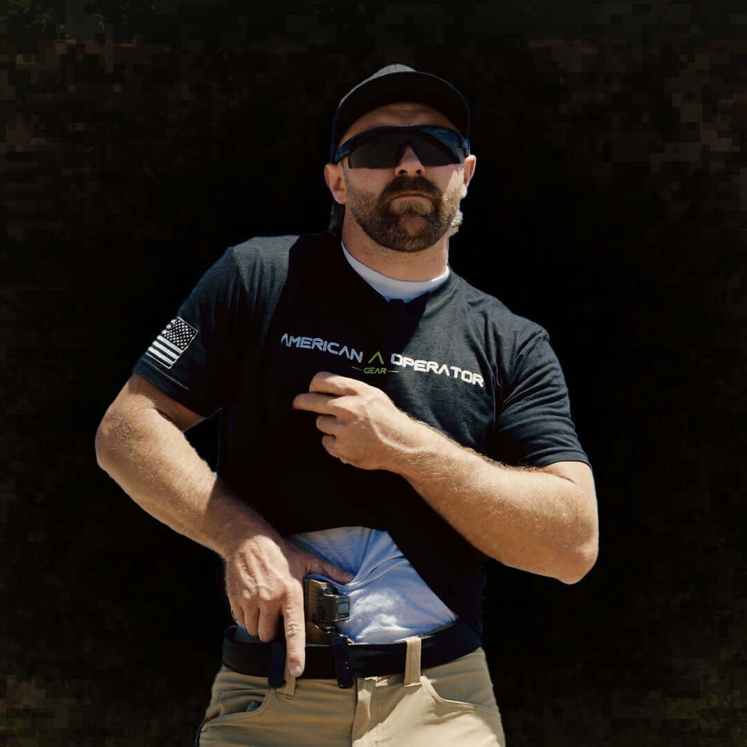Man wearing an American Operator T-Shirt, showcasing a modern design and patriotic style while reaching for a concealed item.